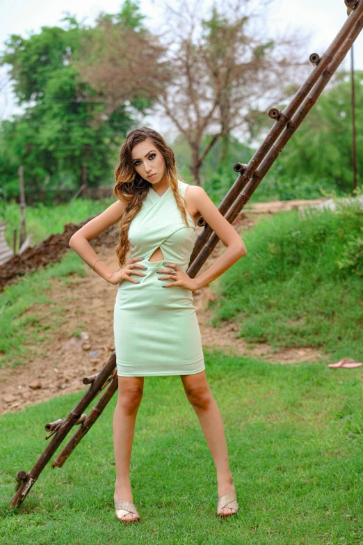 a woman standing on top of a lush green field, a portrait, pexels contest winner, happening, skintight dress, indian super model, 18 years old, trending on artstion