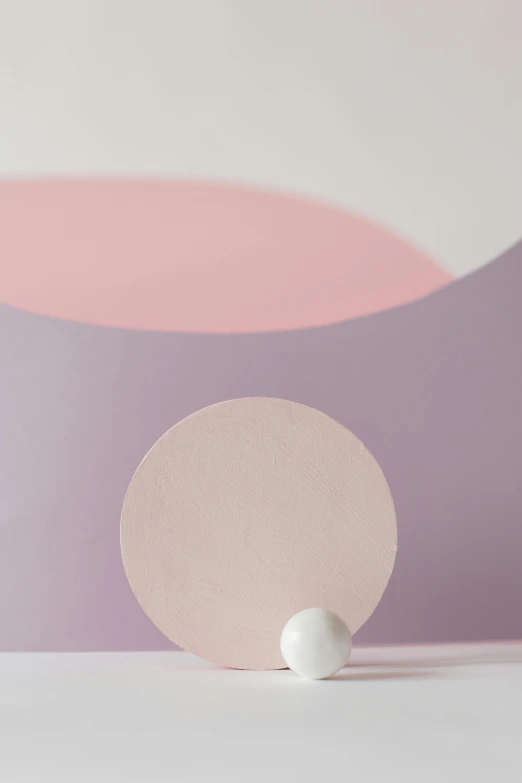 a white egg sitting on top of a table, an abstract sculpture, by Doug Ohlson, trending on unsplash, conceptual art, pink and purple, detail shot, light circles, paper cut out collage artwork