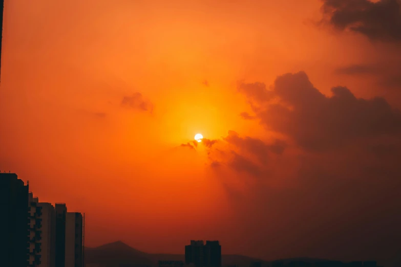 the sun is setting over the city skyline, pexels contest winner, romanticism, orange halo, hot and humid, asian sun, landscape photo