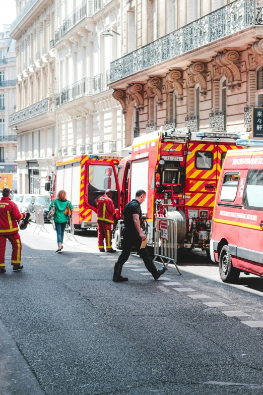 a group of emergency vehicles parked on the side of a street, by Nina Hamnett, pexels contest winner, renaissance, paris, people walking around, square, high quality photo