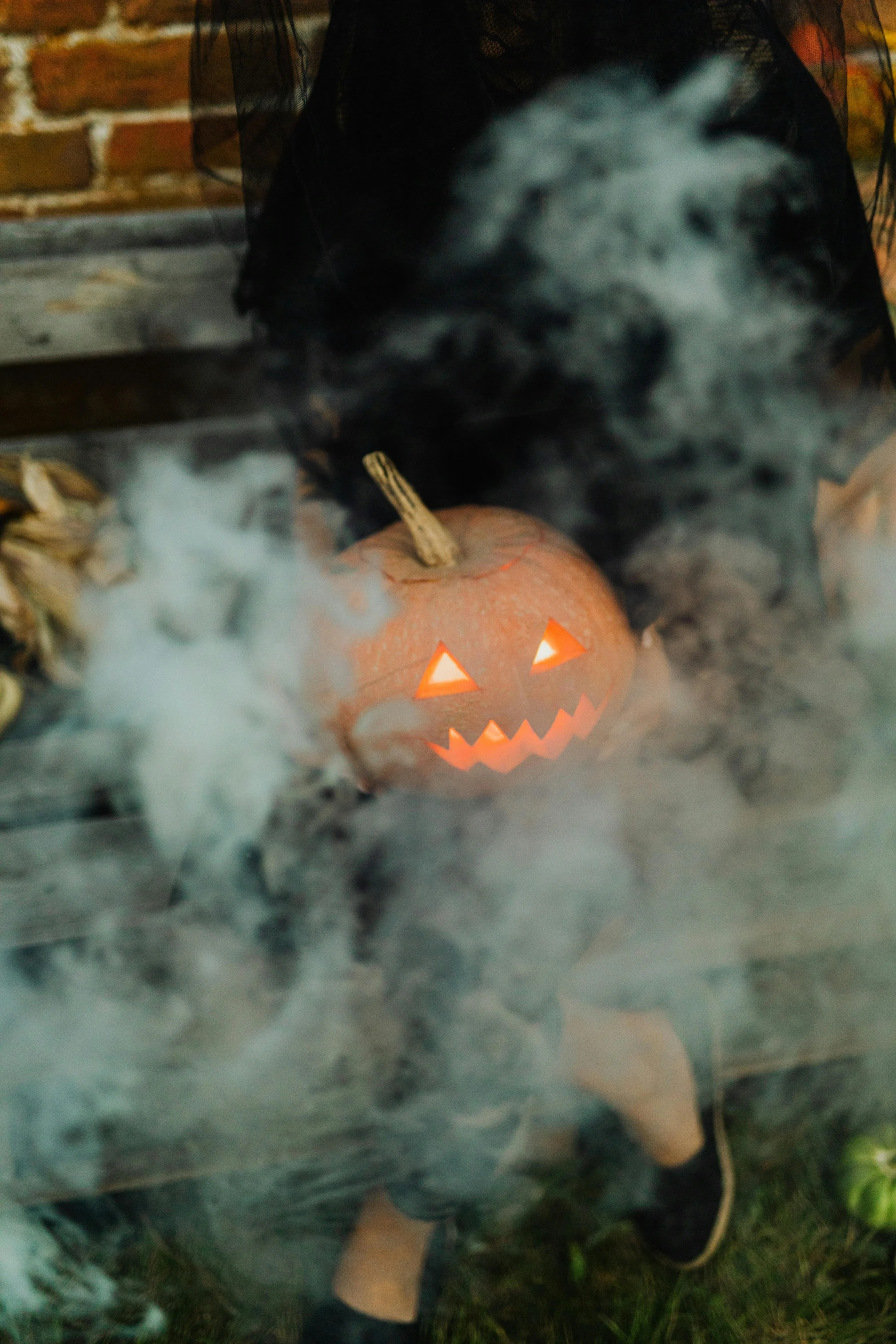 a woman sitting on a bench holding a jack - o - lantern, by Niko Henrichon, shutterstock, incense smoke fills the air, promo image, dry ice, instagram post