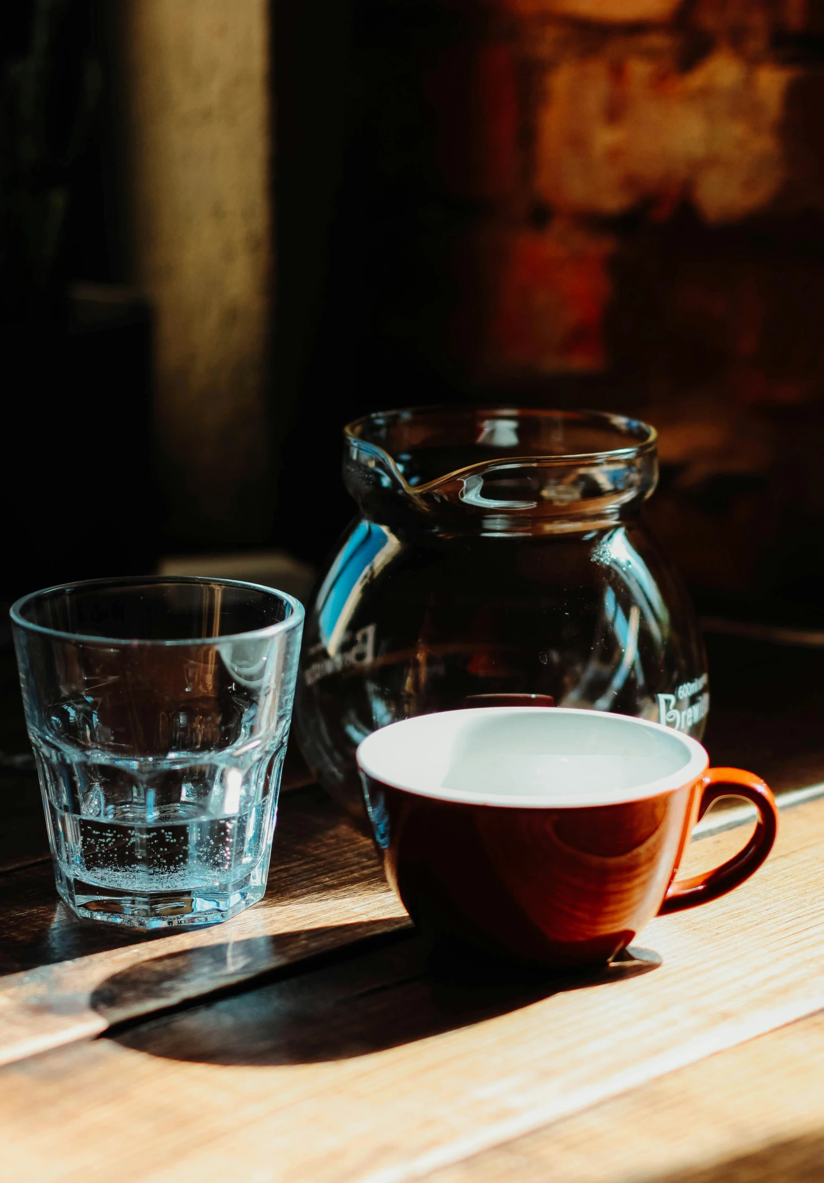 a cup of coffee sitting on top of a wooden table, glassware, thumbnail