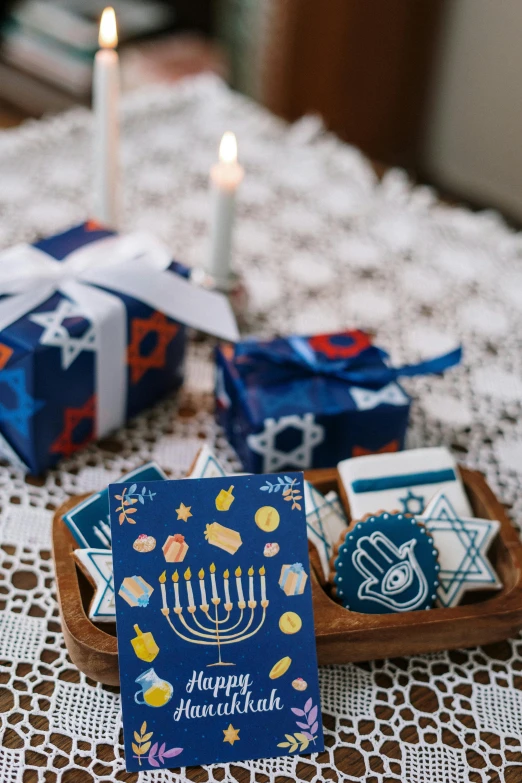 a bunch of cards sitting on top of a table, by Julia Pishtar, dau-al-set, delivering parsel box, cozy candlelight, blue themed, religious