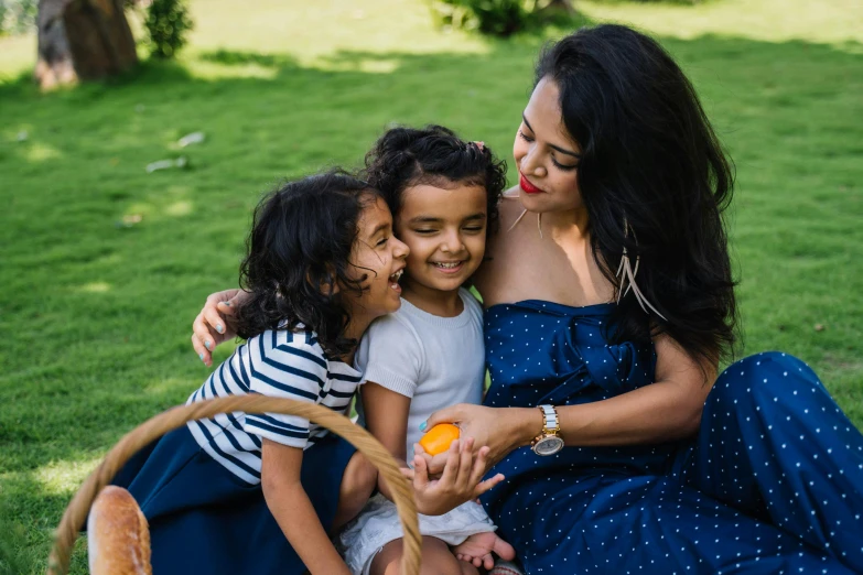 a woman and two young girls sitting on the grass, pexels contest winner, hurufiyya, mango, avatar image, husband wife and son, indian girl with brown skin