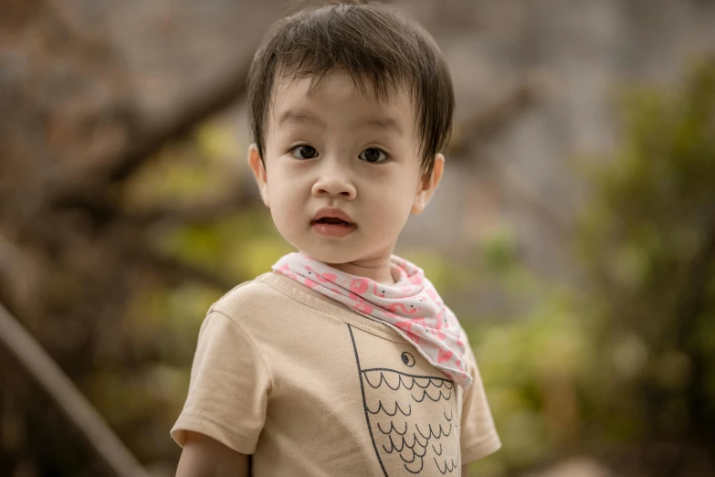 a small child wearing a t - shirt with an owl on it, pexels contest winner, happening, patterned scarf, ross tan, triangular face, subtle detailing
