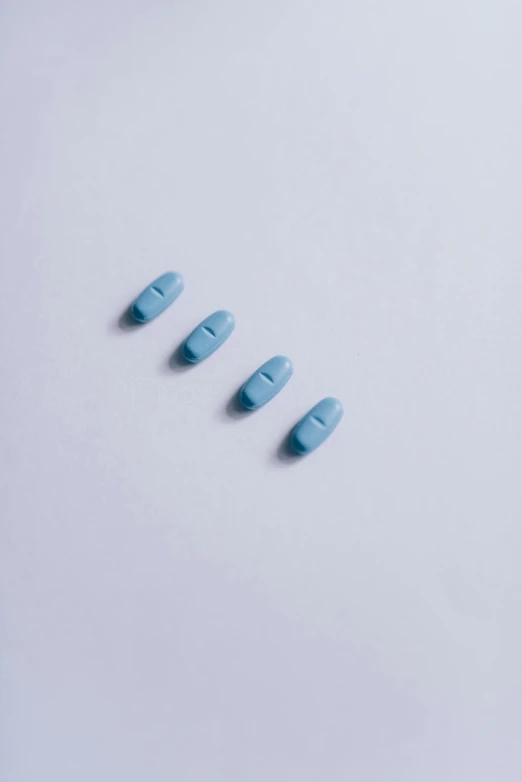 blue pills on a white background, by Ryan Pancoast, visual art, teal color graded, in a row, official product photo, mid riff