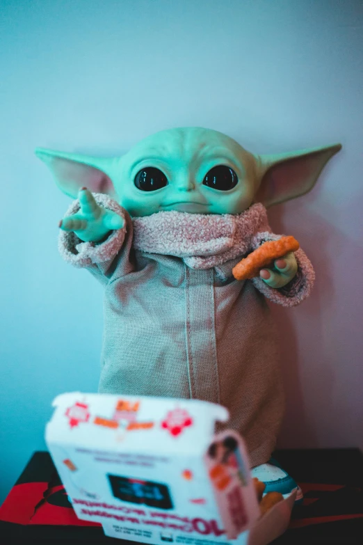 a close up of a stuffed baby yogurt, a hologram, pexels contest winner, star wars character, green and brown clothes, toy photo, morning time