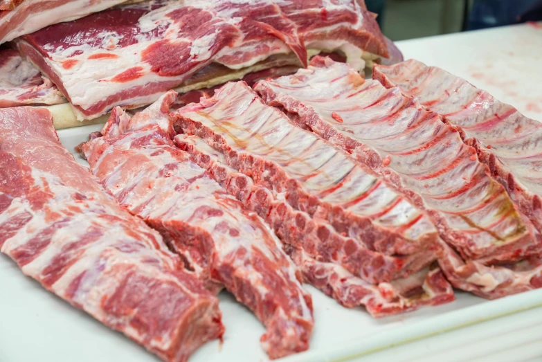 a pile of meat sitting on top of a cutting board, rib cage exposed, rows of razor sharp teeth, celtic, 6 pack