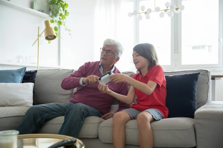 a man and a woman sitting on a couch playing a video game, a picture, pexels contest winner, grandfatherly, kids playing, v tuber, aged 13