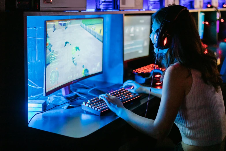 a woman playing a video game on a computer, trending on pexels, server in the middle, avatar image, instagram post, blue light accents