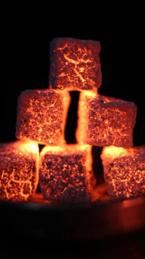 a pile of marshmallows sitting on top of a plate, by David Donaldson, pexels, streams of glowing hot lava, lit. 'the cube', graphite, high angle close up shot