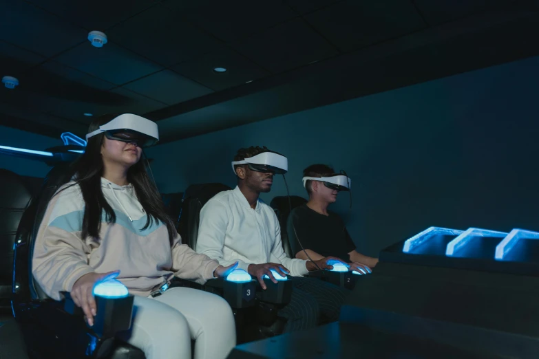 a group of people wearing virtual reality headsets, a hologram, sitting down, **cinematic, shot with sony alpha 1 camera, avatar image
