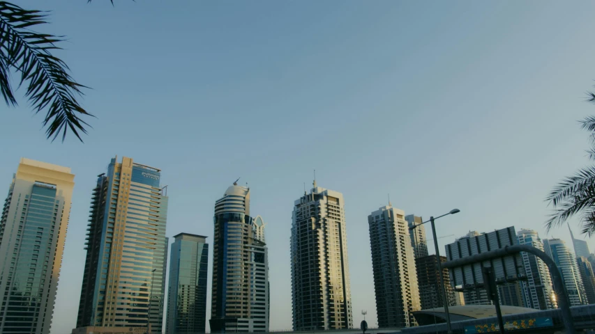 a bunch of tall buildings in a city, a screenshot, pexels contest winner, hurufiyya, middle east, clear sky above, shot on sony alpha dslr-a300, various posed