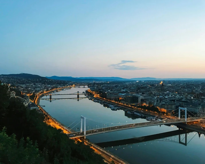 a view of a bridge over a body of water, by Daniel Lieske, pexels contest winner, happening, budapest, panoramic view, vista of a city at sunset, wide high angle view