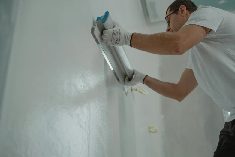 a man is painting a wall with a paint roller, a hyperrealistic painting, by Jan Kupecký, pexels contest winner, hyperrealism, white concrete, background image, thumbnail, decoration