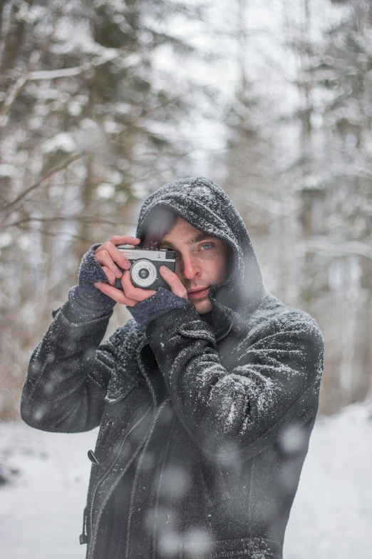 a man taking a picture of himself in the snow, pexels contest winner, photorealism, grey, male model, avatar image, casual photography