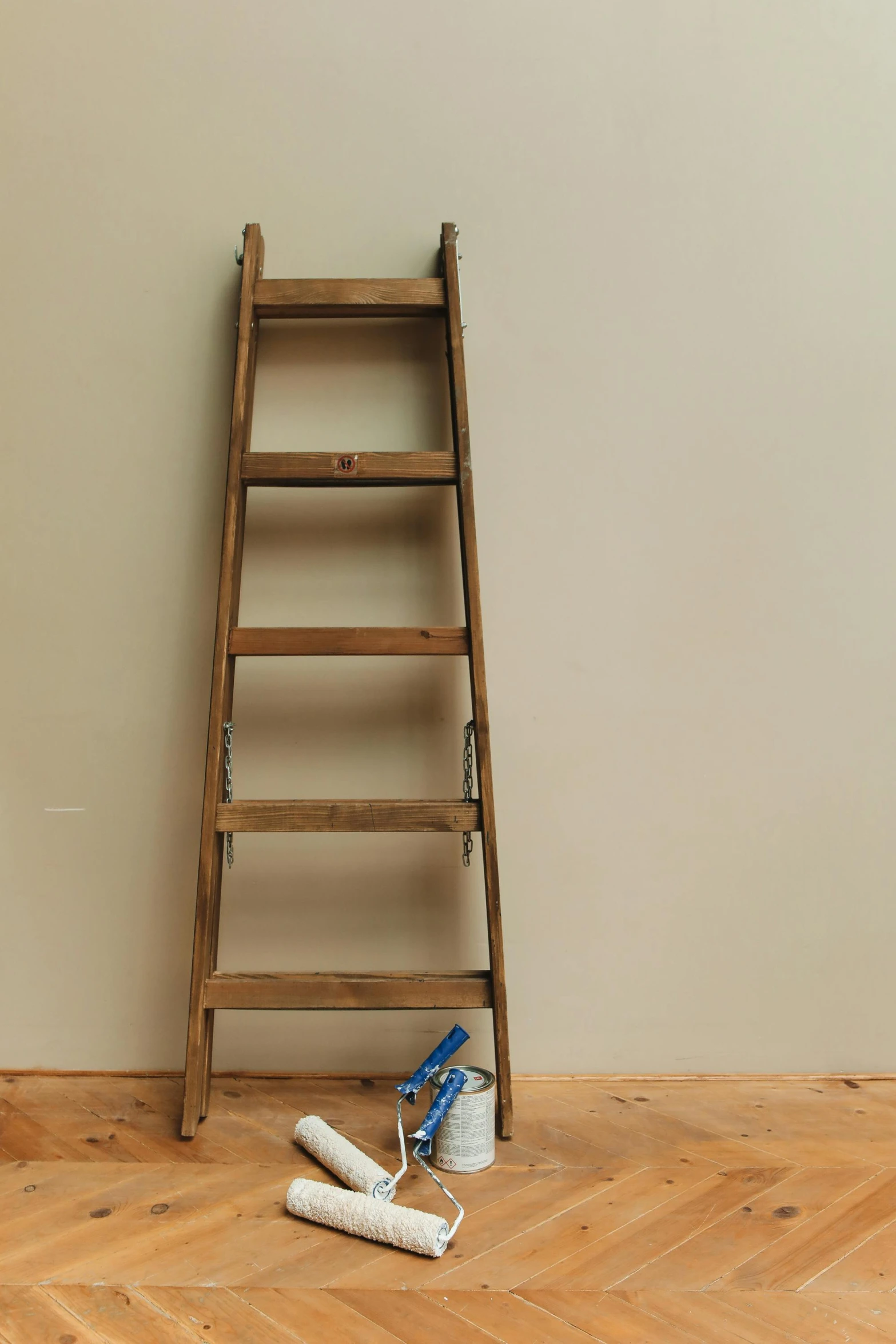 a ladder leaning against a wall next to a pair of shoes, tools, ecommerce photograph, panel, laura watson