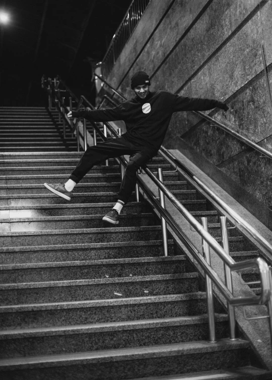 a man riding a skateboard down a flight of stairs, a black and white photo, by Felix-Kelly, striking a pose, midnight, sneaker photo, looking happy