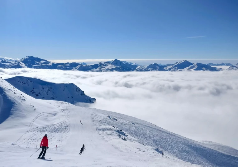 a man riding skis down a snow covered slope, view above the clouds, chairlifts, avatar image