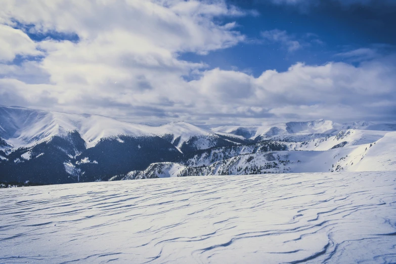 a man riding skis on top of a snow covered slope, pexels contest winner, visual art, vast expansive landscape, 1990's photo, big sky, thumbnail