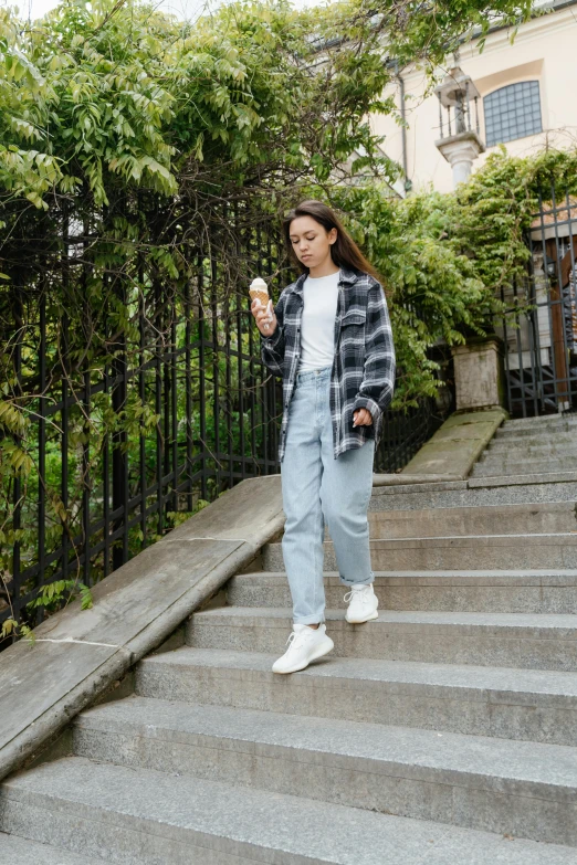 a woman walking down a set of stairs, pexels contest winner, happening, wearing a flannel shirt, ice cream on the side, portrait sophie mudd, 15081959 21121991 01012000 4k