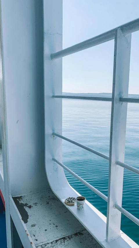 a close up of a window on a boat, by Carey Morris, pexels contest winner, floor - to - ceiling windows, blue sea, low quality photo, demur