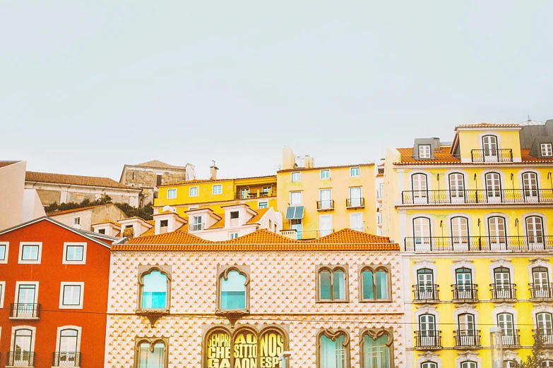 a group of buildings that are next to each other, pexels contest winner, post-impressionism, portugal, airy colors, square, bright sky