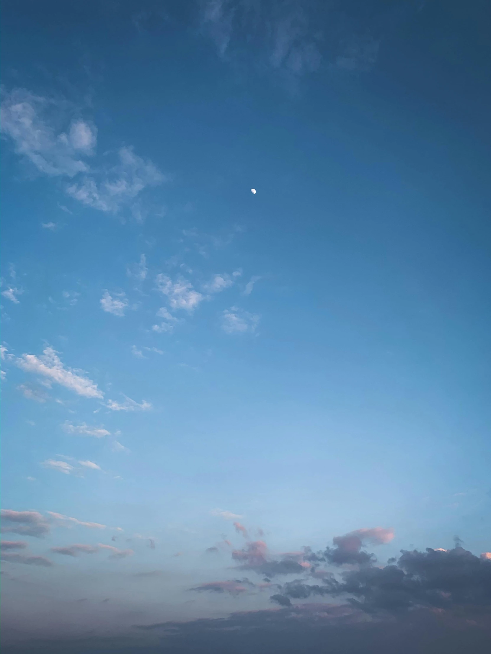 a person flying a kite on top of a beach, a picture, inspired by Elsa Bleda, unsplash, minimalism, blue sky background with moon, low quality photo, ☁🌪🌙👩🏾, pretty clouds