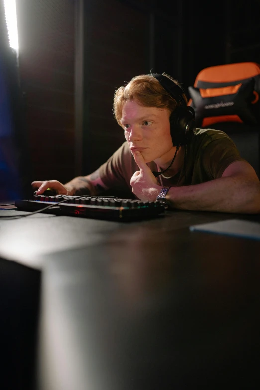 a man sitting at a desk in front of a computer, reddit, tournament, worksafe. cinematic, promo image, close angle