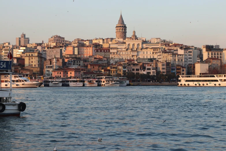 a group of boats floating on top of a body of water, pexels contest winner, hurufiyya, fallout style istanbul, late afternoon, building along a river, 2 5 6 x 2 5 6