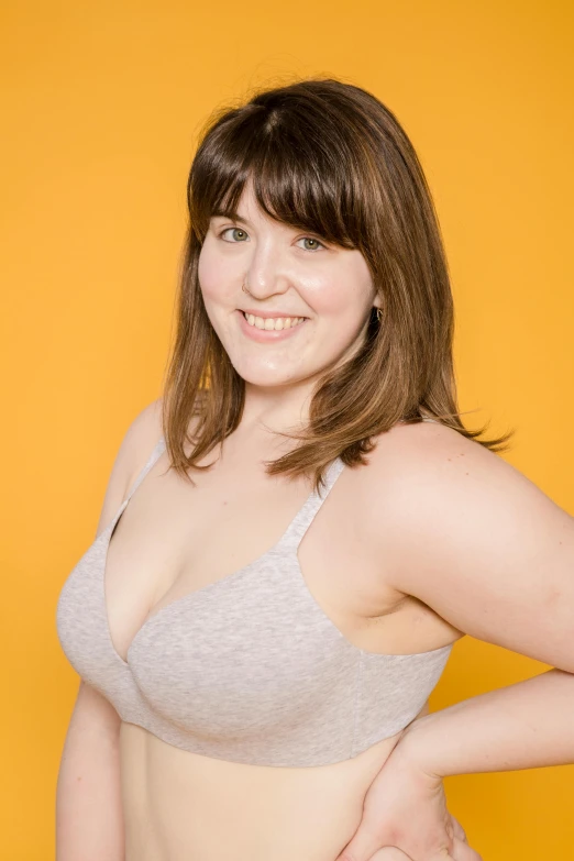a woman in a bra top posing for a picture, by Arabella Rankin, professional product photo, slightly overweight, 2 7 years old, rebecca sugar