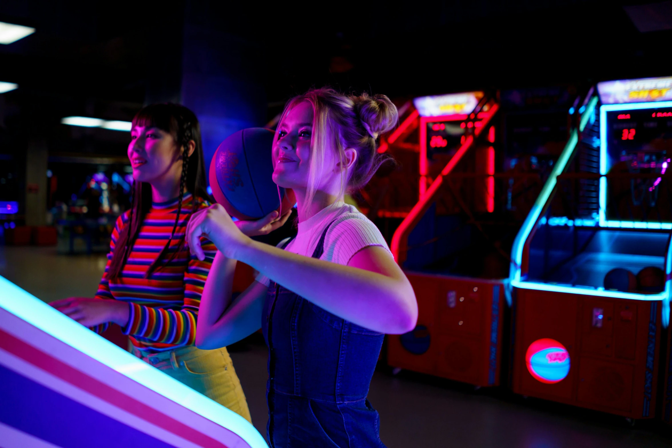 a couple of people that are playing a game, neon rim light, charli bowater and artgeem, bounce light, person in foreground