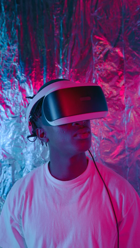a man wearing a virtual reality headset, a hologram, pexels, afrofuturism, black teenage boy, mid shot portrait, '0 0 s nostalgia, redshift vibes