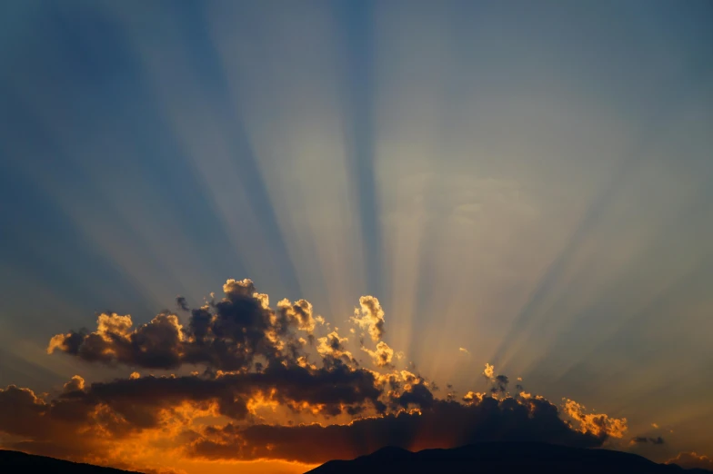 the sun is shining through the clouds over the mountains, pexels contest winner, light and space, refracted sunset, rays of god, journalism photo, light show