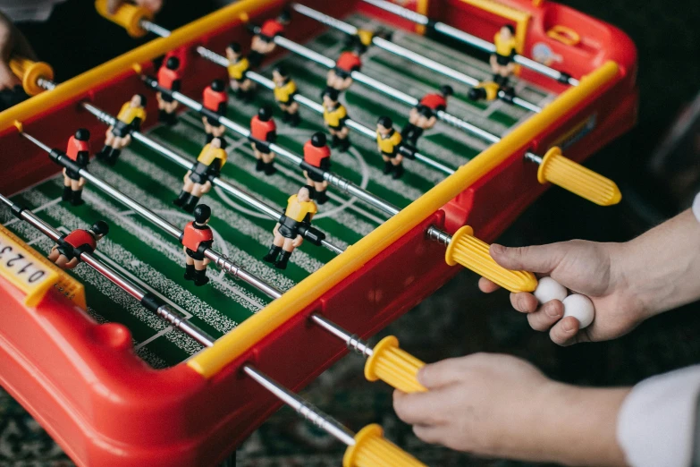 a red and yellow foo foo foo foo foo foo foo foo foo foo foo foo foo foo, by Julia Pishtar, pexels contest winner, interactive art, playing soccer, board games on a table, newton's cradle