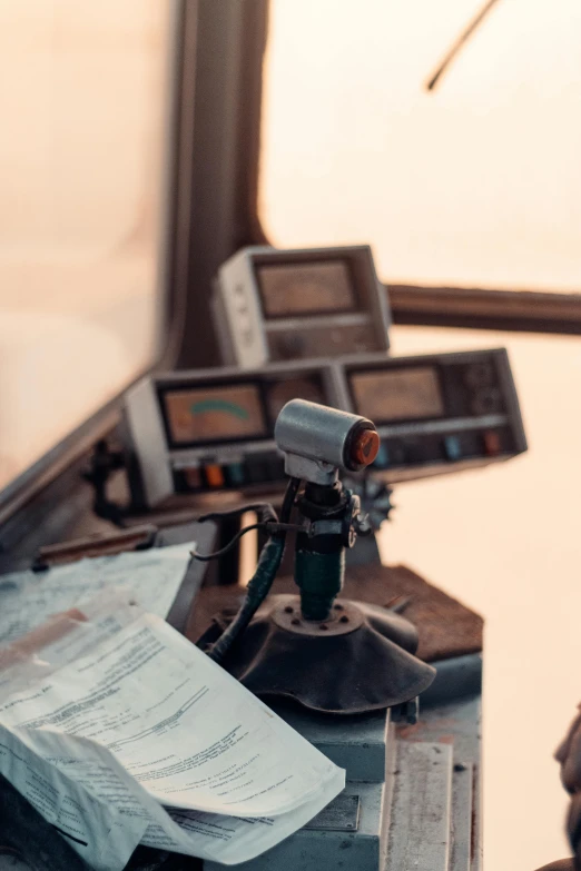 a man sitting at a desk in front of a computer, a picture, by Adam Marczyński, private press, ship control panel close-up, cybertruck, vintage color, 2 5 6 x 2 5 6 pixels