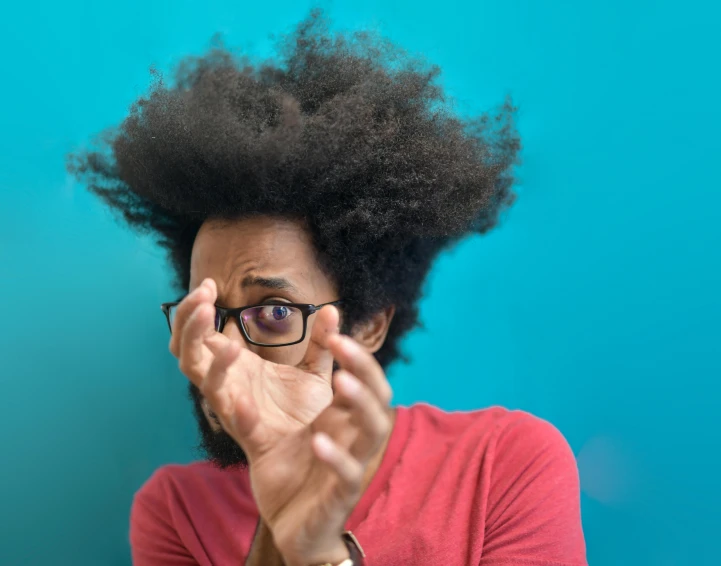 a man with glasses covering his face with his hands, an album cover, by Washington Allston, pexels contest winner, precisionism, afro hair, surprised expression, avatar image, youtube thumbnail