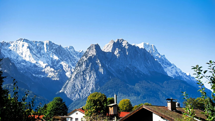 a group of houses with mountains in the background, by Niko Henrichon, pexels contest winner, herzog de meuron, avatar image, clear blue skies, 2000s photo