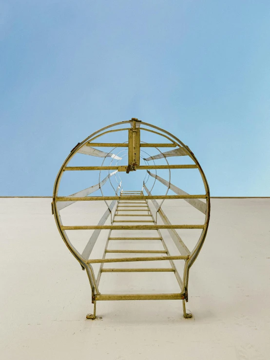 a metal structure on a white surface with a blue sky in the background, an album cover, ladder, sculpture made of gold, curvature, trending on artforum