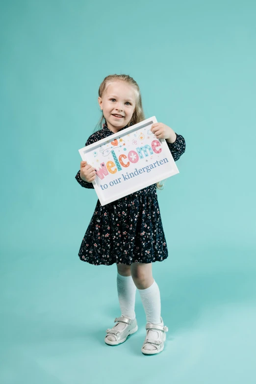 a little girl holding a sign that says welcome, shutterstock contest winner, incoherents, full colour print, studio photoshoot, patterned, product introduction photo
