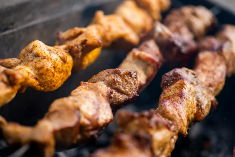 a close up of some meat on a grill, by Niko Henrichon, unsplash, hurufiyya, middle eastern skin, 15081959 21121991 01012000 4k