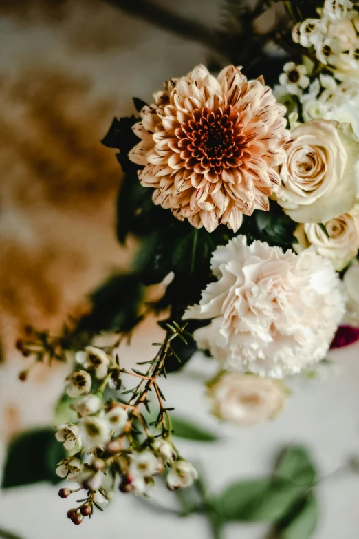 a bouquet of flowers sitting on top of a table, by Elsie Few, unsplash, baroque, gnarly details soft light, ivory and copper, closeup, layered detailed