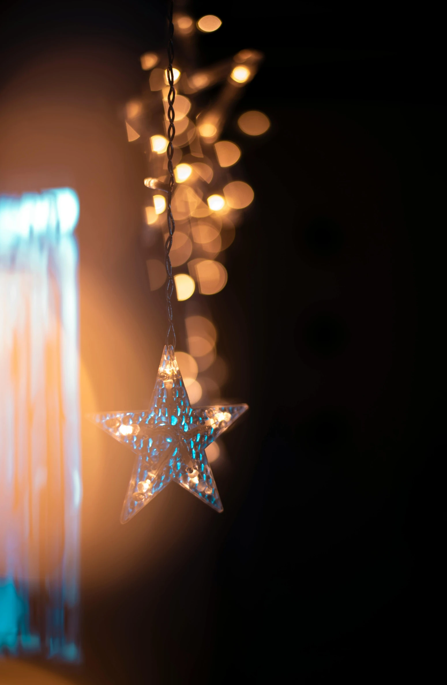 a close up of a star hanging from a string, a picture, light and space, windows lit up, full res, reflection of led lights, profile image
