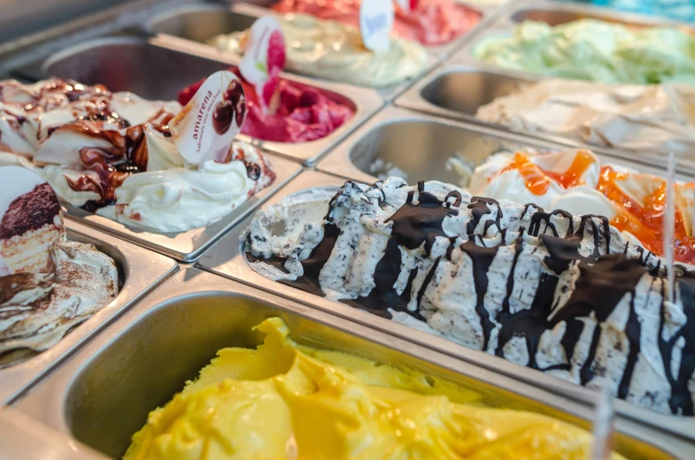 a display case filled with lots of different types of ice cream, trending on unsplash, process art, fan favorite, wafflehouse, closeup - view, “ iron bark