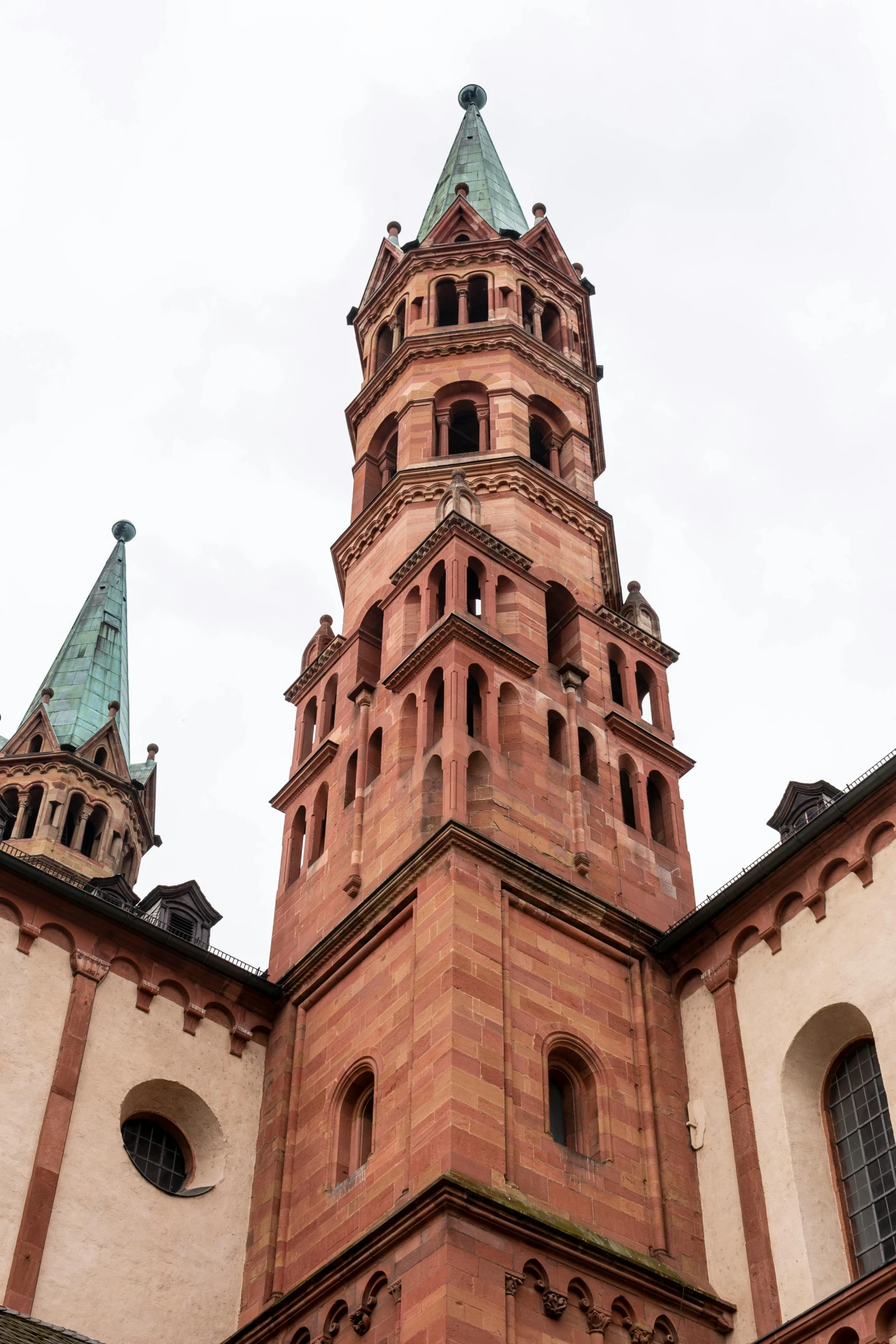 a tall tower with a clock on top of it, inspired by Rainer Maria Latzke, romanesque, lead - covered spire, pink marble building, details galore, panorama