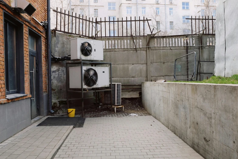 a couple of air conditioners sitting on the side of a building, a photo, unsplash, temporary art, post - soviet courtyard, background image, underground room, hammershøi