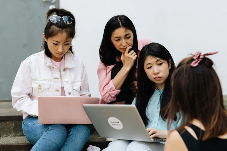 three women sitting on steps looking at a laptop, trending on pexels, young asian girl, school class, avatar image, alana fletcher