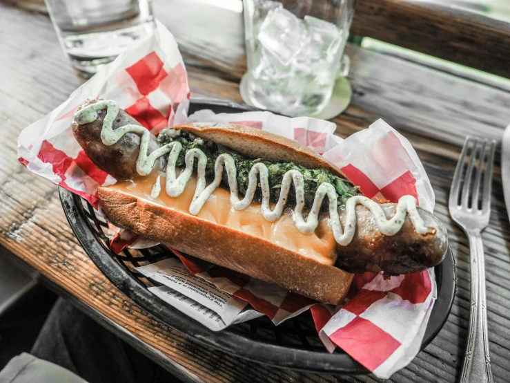 a hot dog sitting on top of a bun covered in ketchup, by Matt Cavotta, pexels contest winner, green skinned, on a wooden tray, 💋 💄 👠 👗, al fresco