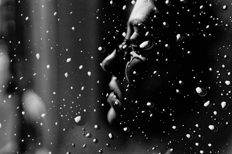 a black and white photo of a man in the rain, a black and white photo, by Lucia Peka, pexels, conceptual art, snowflakes falling, close face view, saatchi art, beads of sweat