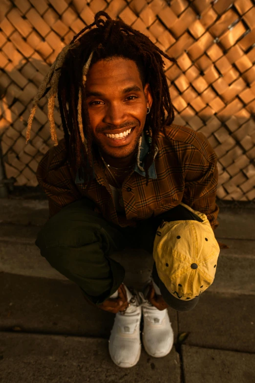 a man with dreadlocks holding a teddy bear, an album cover, inspired by Ismail Gulgee, trending on unsplash, smiley face, holding a gold bag, looking to camera, late evening